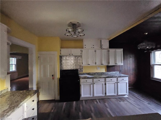 kitchen with dark wood-type flooring, white cabinets, and a healthy amount of sunlight