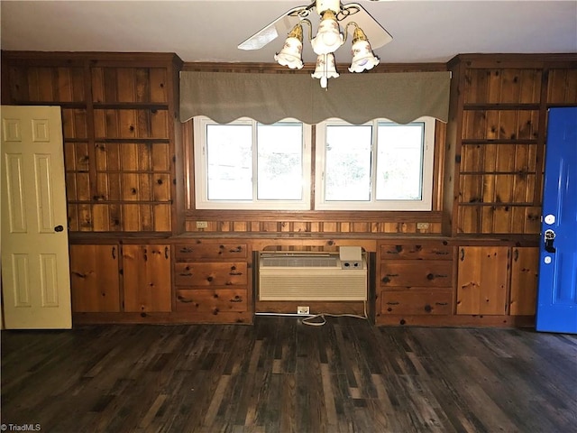 unfurnished dining area with dark hardwood / wood-style floors and an AC wall unit