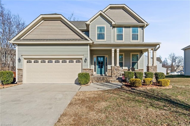 craftsman inspired home featuring a garage, covered porch, and a front lawn