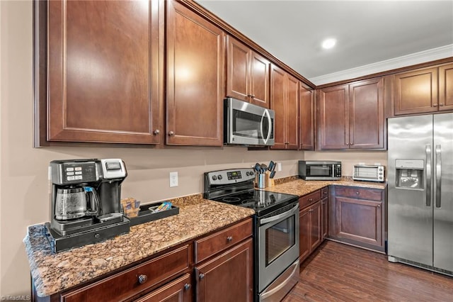 kitchen featuring appliances with stainless steel finishes, dark hardwood / wood-style flooring, light stone counters, and crown molding