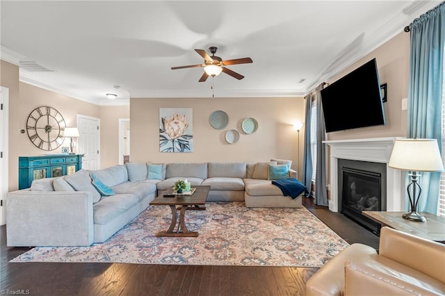 living room featuring crown molding, ceiling fan, and dark hardwood / wood-style floors