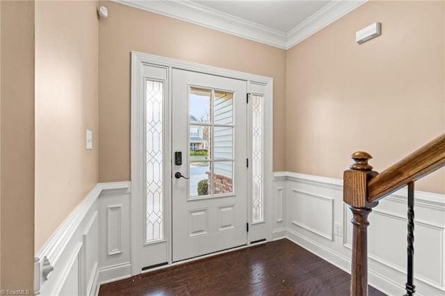 foyer with dark wood-type flooring and ornamental molding