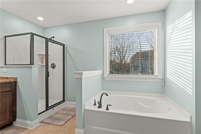 bathroom with tile patterned floors, vanity, and shower with separate bathtub