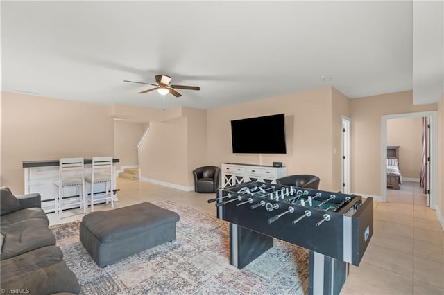 rec room featuring tile patterned floors, ceiling fan, and baseboard heating