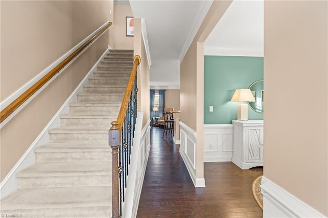 staircase featuring hardwood / wood-style flooring and ornamental molding