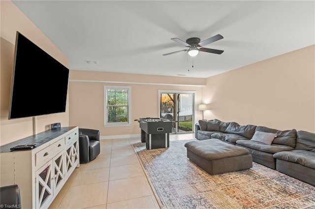 living room featuring light tile patterned floors and ceiling fan