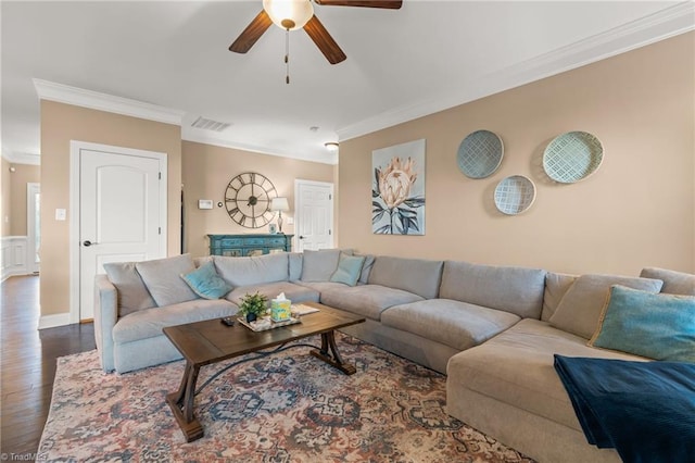 living room with dark hardwood / wood-style floors, ceiling fan, and crown molding