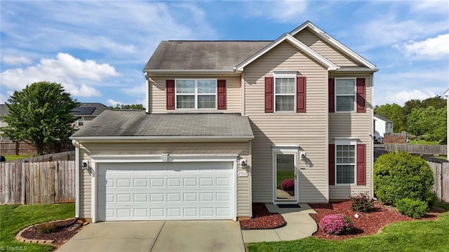 2503 Macdougall Dr, Burlington, NC 27217 - view of front facade with fence, concrete driveway, a shingled roof, and an attached garage