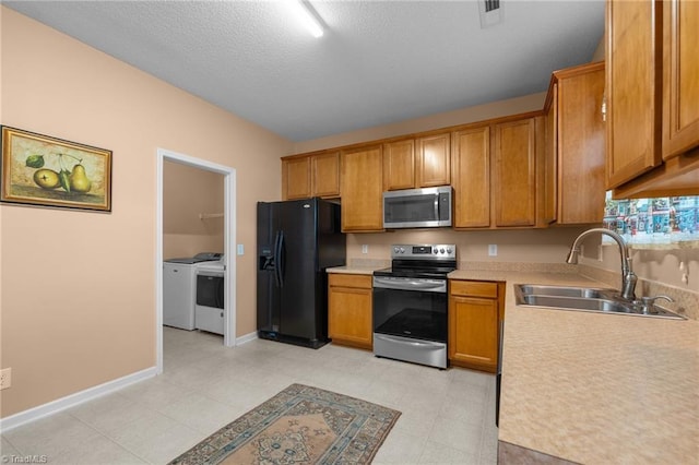 2503 Macdougall Dr, Burlington, NC 27217 - kitchen featuring brown cabinetry, appliances with stainless steel finishes, light countertops, a sink, and visible vents