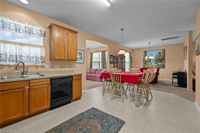 2503 Macdougall Dr, Burlington, NC 27217 - kitchen with visible vents, brown cabinetry, dishwasher, and a sink