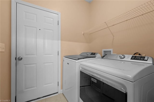 2503 Macdougall Dr, Burlington, NC 27217 - laundry area with light tile patterned floors, washing machine and clothes dryer, and laundry area
