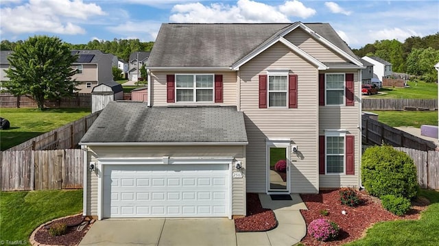2503 Macdougall Dr, Burlington, NC 27217 - traditional-style home with driveway, roof with shingles, a front lawn, and a fenced backyard