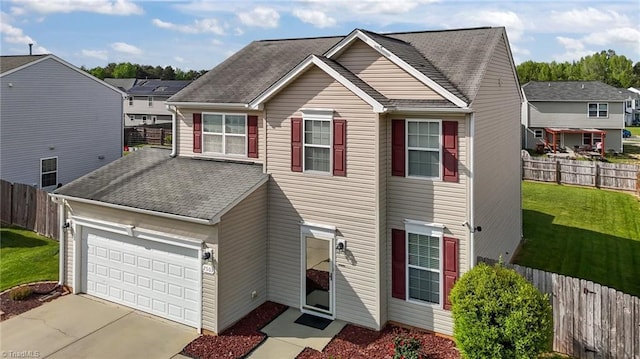 2503 Macdougall Dr, Burlington, NC 27217 - traditional home featuring concrete driveway, a shingled roof, a front yard, an attached garage, and fence