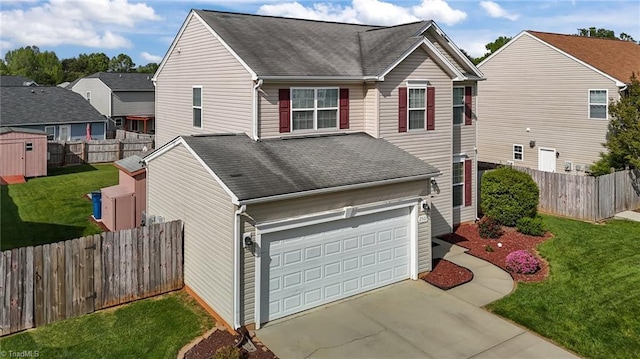 2503 Macdougall Dr, Burlington, NC 27217 - view of front facade featuring a fenced backyard, a garage, roof with shingles, a front lawn, and concrete driveway