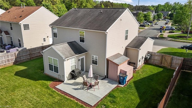 2503 Macdougall Dr, Burlington, NC 27217 - rear view of house featuring a patio area, an outbuilding, a fenced backyard, a lawn, and a storage unit