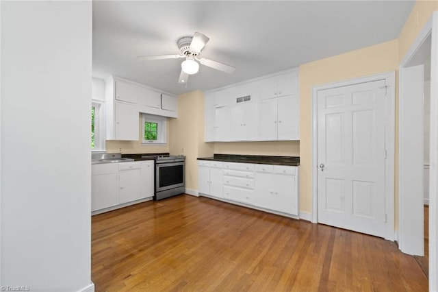 986 Avon Rd, Winston-Salem, NC 27104 - kitchen featuring white cabinets, gas stove, and wood finished floors