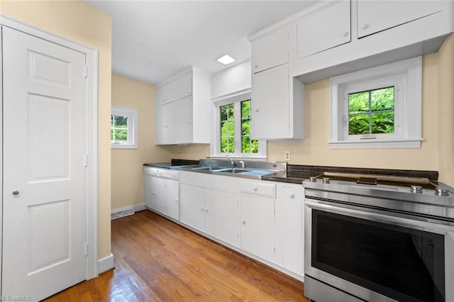 986 Avon Rd, Winston-Salem, NC 27104 - kitchen featuring stainless steel electric range, healthy amount of natural light, a sink, and white cabinetry