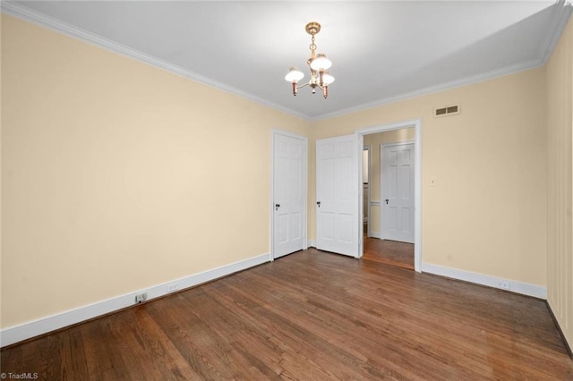 986 Avon Rd, Winston-Salem, NC 27104 - spare room featuring a chandelier, dark wood-style floors, baseboards, and ornamental molding