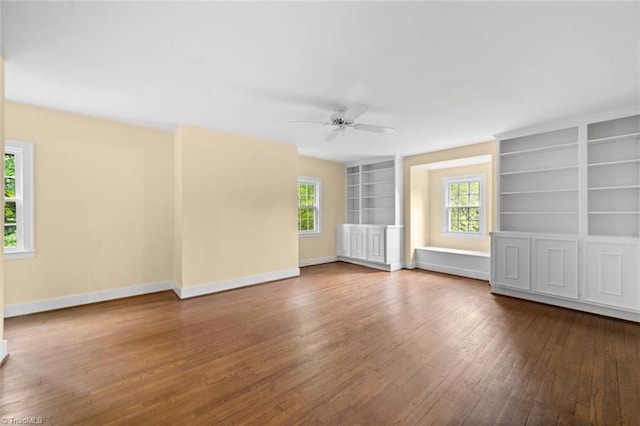 986 Avon Rd, Winston-Salem, NC 27104 - unfurnished living room featuring dark wood-type flooring, healthy amount of natural light, ceiling fan, and built in features