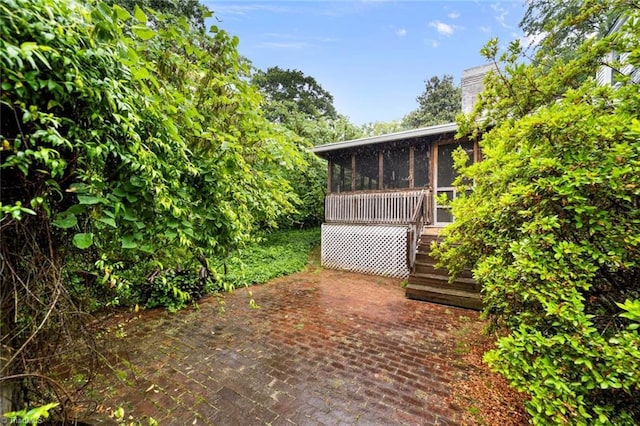 986 Avon Rd, Winston-Salem, NC 27104 - exterior space featuring a sunroom, a patio area, and a chimney