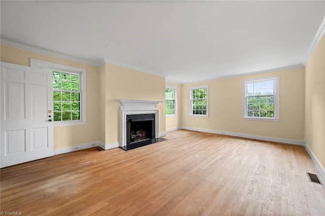 986 Avon Rd, Winston-Salem, NC 27104 - unfurnished living room featuring crown molding, light wood-style floors, plenty of natural light, and baseboards