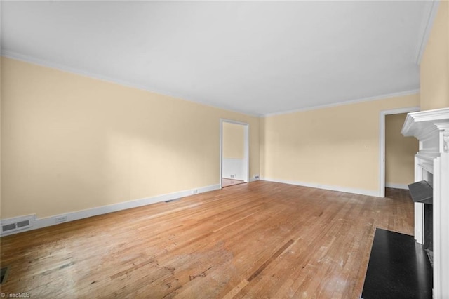 986 Avon Rd, Winston-Salem, NC 27104 - unfurnished living room with a fireplace with flush hearth, light wood finished floors, crown molding, and baseboards