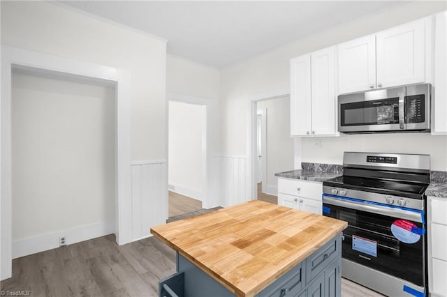 4221 Old Greensboro Rd, Winston-Salem, NC 27101 - kitchen with appliances with stainless steel finishes, wooden counters, white cabinets, light wood-style flooring, and a center island