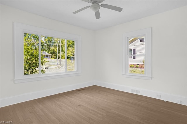 4221 Old Greensboro Rd, Winston-Salem, NC 27101 - unfurnished room with wood finished floors, plenty of natural light, baseboards, and ceiling fan