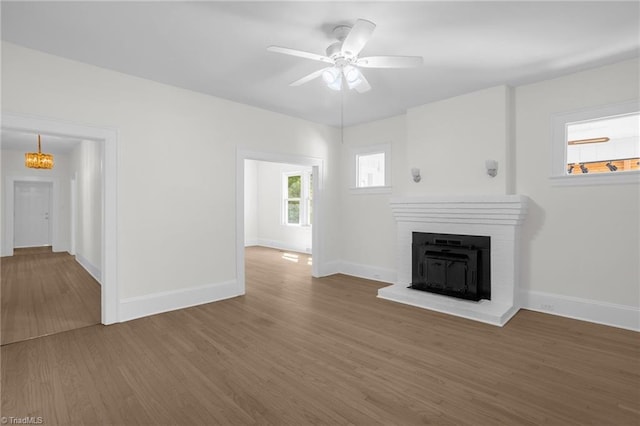 4221 Old Greensboro Rd, Winston-Salem, NC 27101 - unfurnished living room with wood finished floors, baseboards, a fireplace, and a ceiling fan