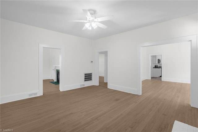 4221 Old Greensboro Rd, Winston-Salem, NC 27101 - unfurnished living room with ceiling fan, wood finished floors, baseboards, and a fireplace with flush hearth