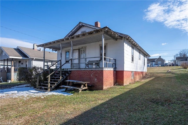 exterior space featuring covered porch and a lawn