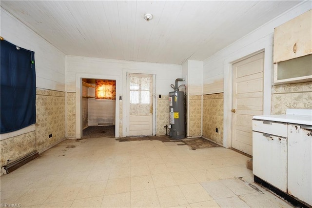 interior space featuring white cabinetry and gas water heater