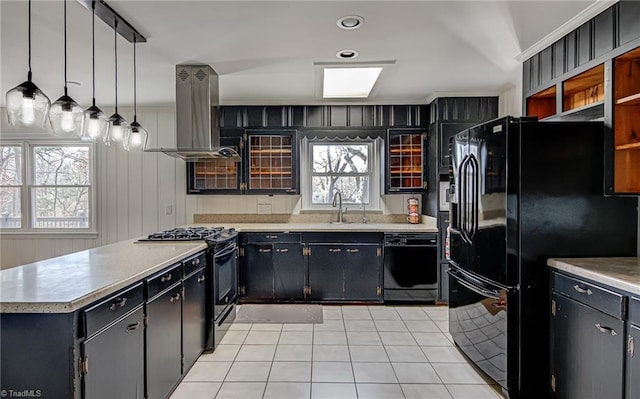 kitchen with island exhaust hood, sink, black appliances, light tile patterned floors, and hanging light fixtures