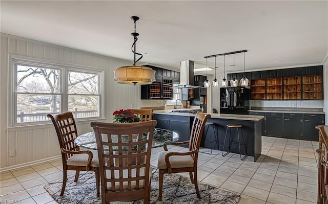 dining area featuring light tile patterned floors and sink