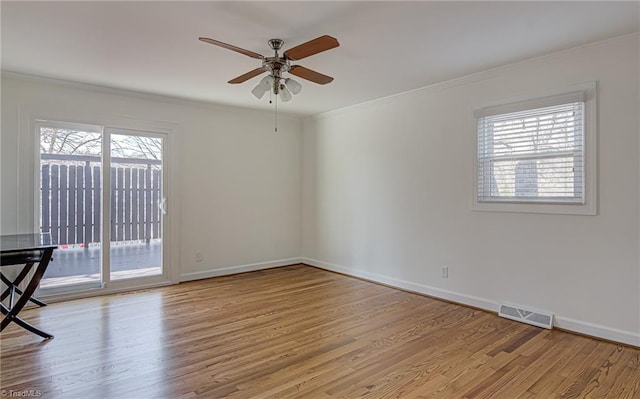 empty room with plenty of natural light, ceiling fan, and light wood-type flooring