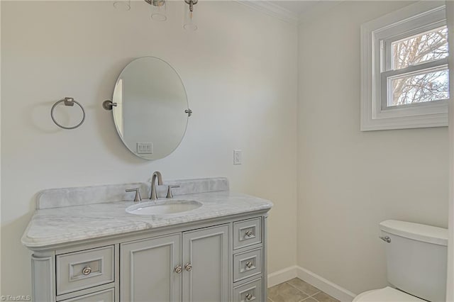 bathroom with toilet, vanity, tile patterned floors, and crown molding