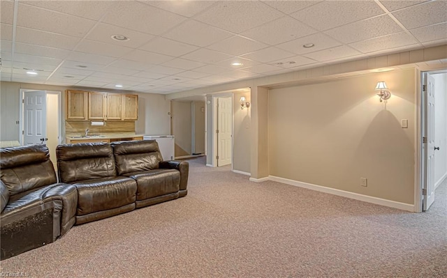 home theater room featuring a drop ceiling, light colored carpet, and sink