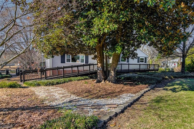 view of side of home featuring a wooden deck