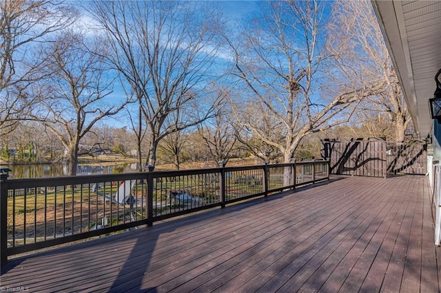 wooden terrace featuring a water view