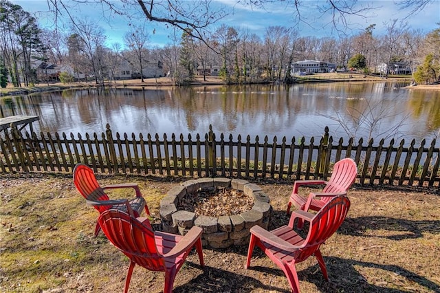 view of yard featuring a water view and an outdoor fire pit