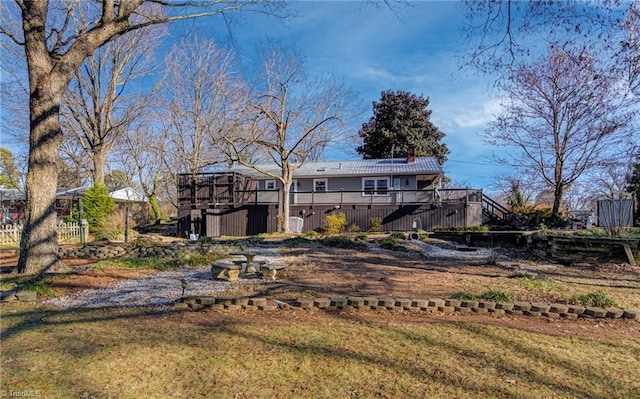 back of house with a yard and a wooden deck