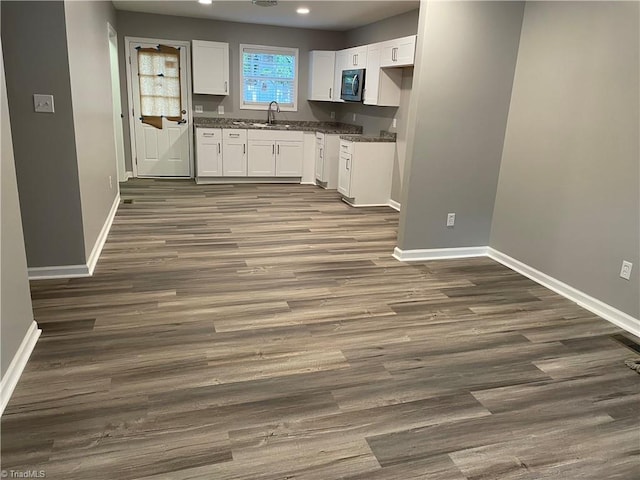 kitchen with white cabinets, dark hardwood / wood-style flooring, and sink