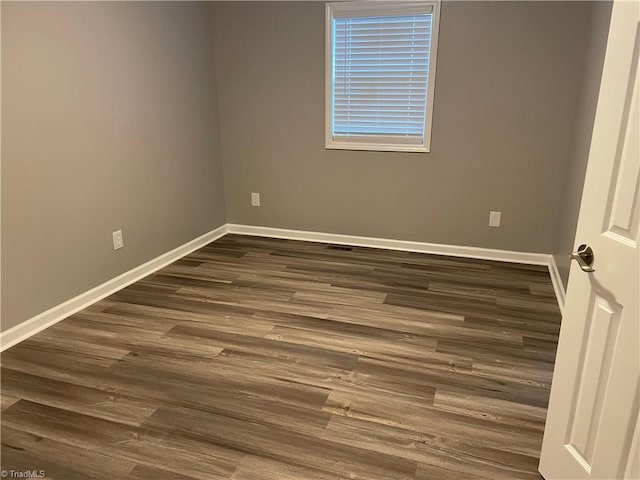 spare room with dark hardwood / wood-style floors