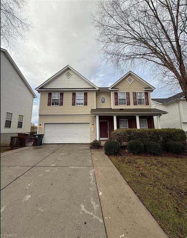 5608 David Christian Pl, Greensboro, NC 27410 - traditional-style house featuring an attached garage and concrete driveway