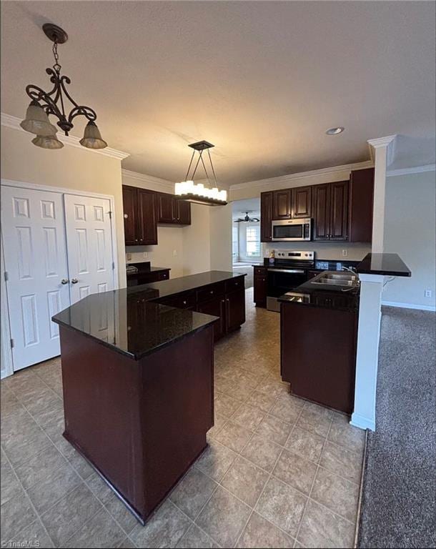 5608 David Christian Pl, Greensboro, NC 27410 - kitchen featuring stainless steel appliances, ornamental molding, a kitchen island, dark brown cabinets, and hanging light fixtures