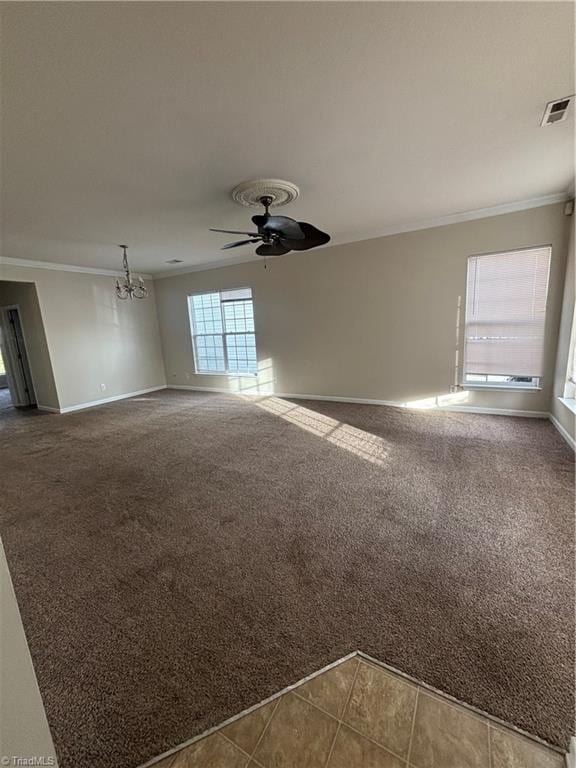 5608 David Christian Pl, Greensboro, NC 27410 - unfurnished living room featuring crown molding, carpet flooring, baseboards, ceiling fan, and a chandelier