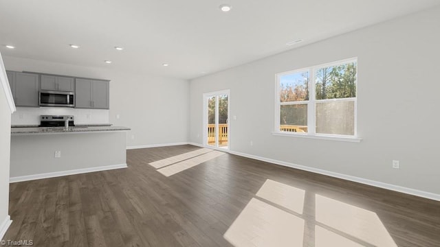 6601 Grogan Hill Rd, Whitsett, NC 27377 - unfurnished living room featuring dark wood finished floors and recessed lighting