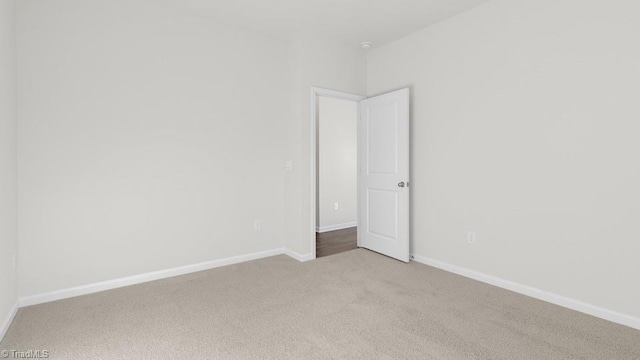 6601 Grogan Hill Rd, Whitsett, NC 27377 - empty room featuring light colored carpet and baseboards