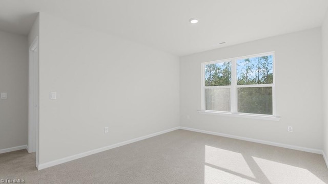 6601 Grogan Hill Rd, Whitsett, NC 27377 - spare room featuring light carpet and recessed lighting