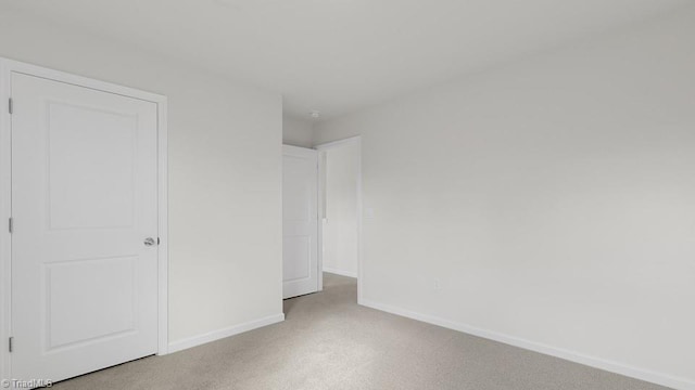 6601 Grogan Hill Rd, Whitsett, NC 27377 - unfurnished bedroom with light colored carpet and baseboards